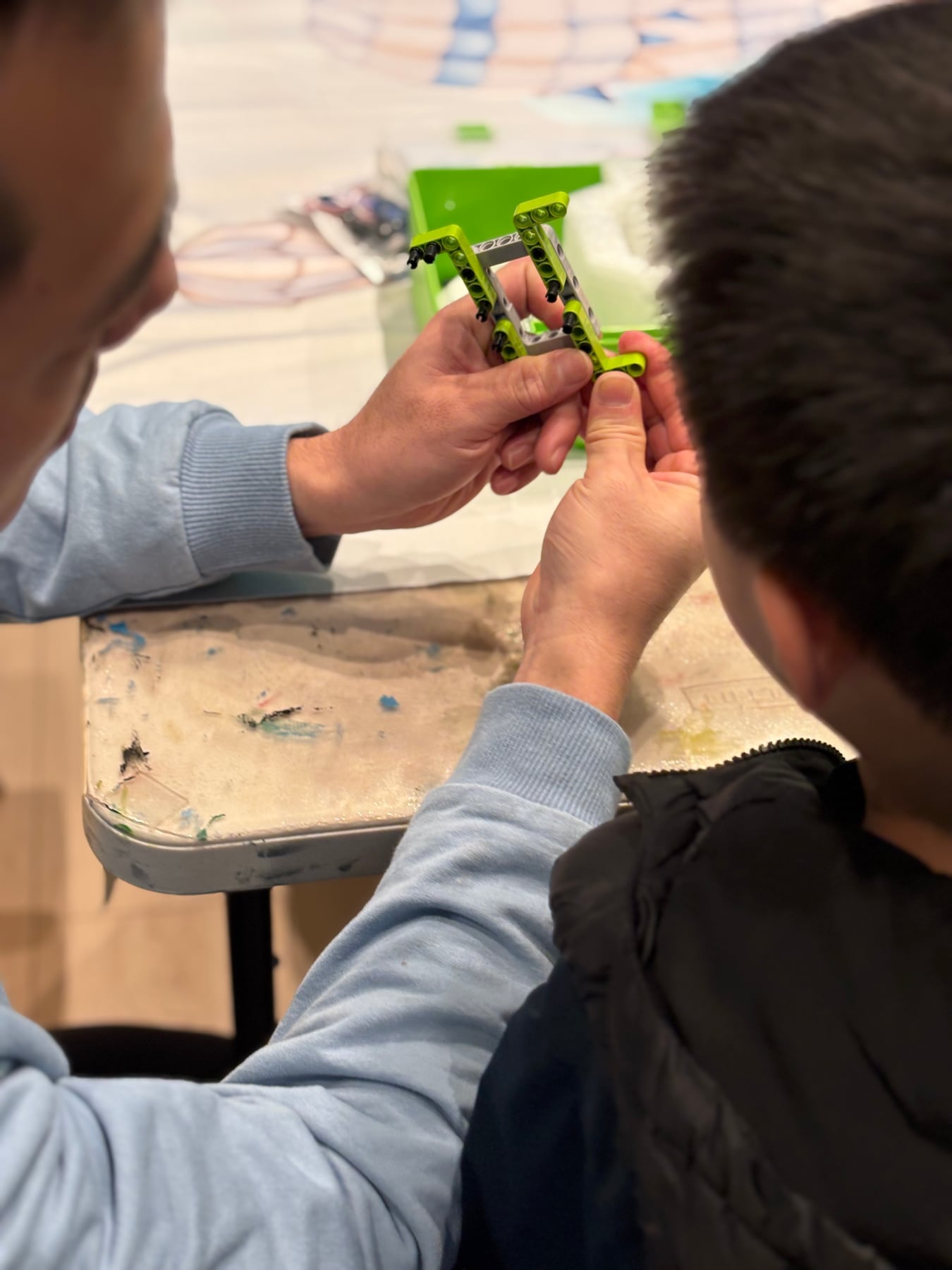 Students working together to assemble a building-block drone frame