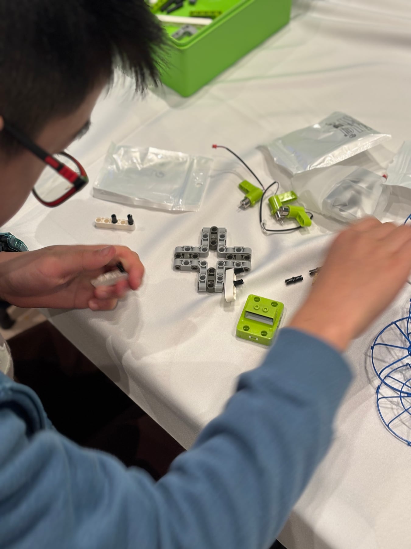 A student assembling motors and structural parts for a drone